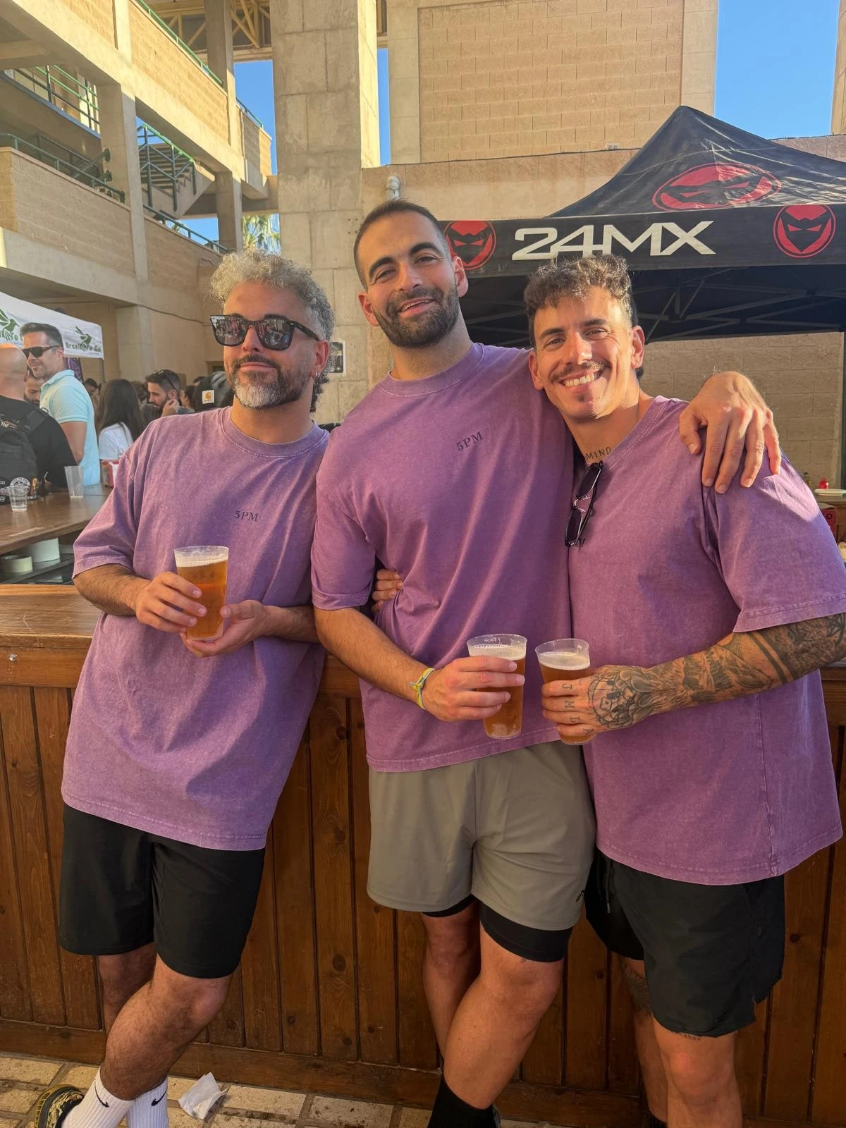Three friends with drinks at a bar